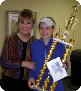 Cindy Brinker Simmons presents trophy to Erin Larner